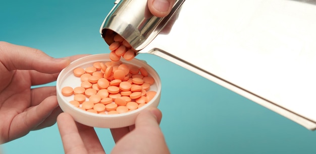 Hand pour pills from count tray on lid