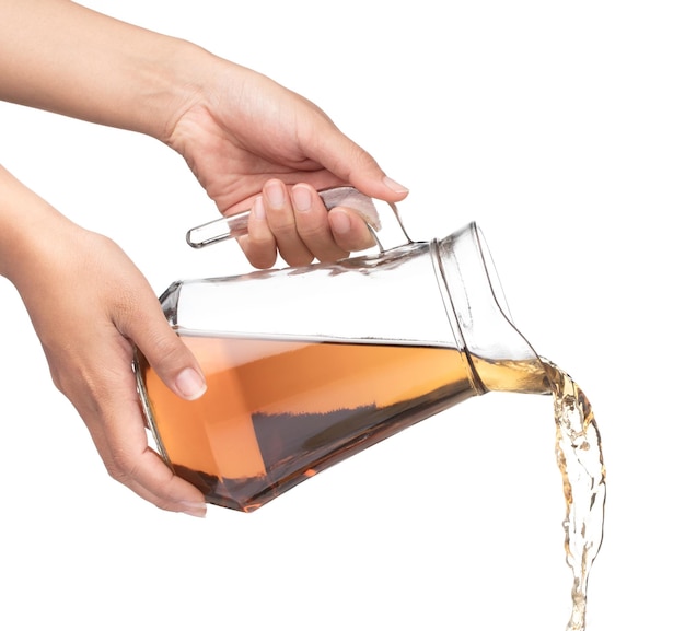 Photo hand pouring jug of tea isolated on a white background