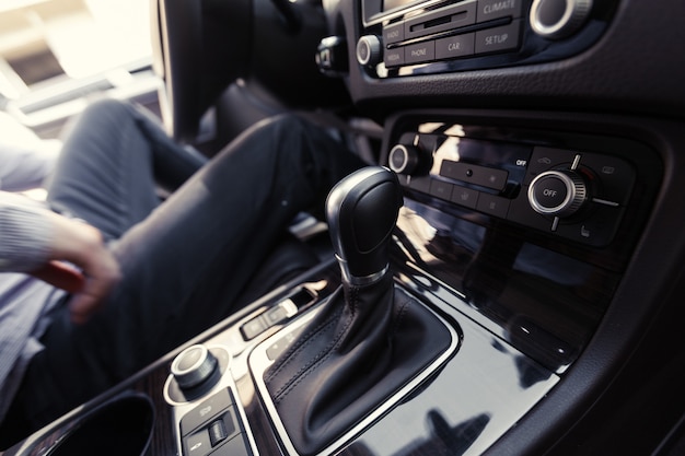 Hand Pushing the power button to turn on the car stereo system