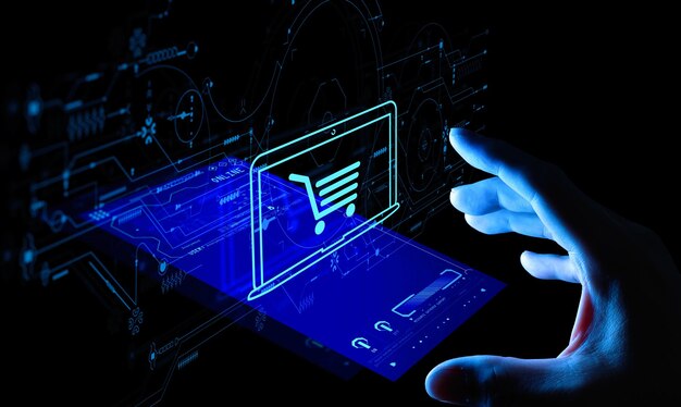 Hand pushing virtual symbol of online shopping with modern UI computer and smart phone.