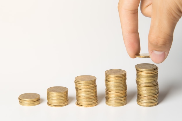 Hand putting coins on stack