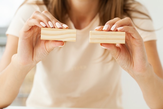 Hand putting and stacking blank wooden cubes on table with copy space for input wording and infographic icon.