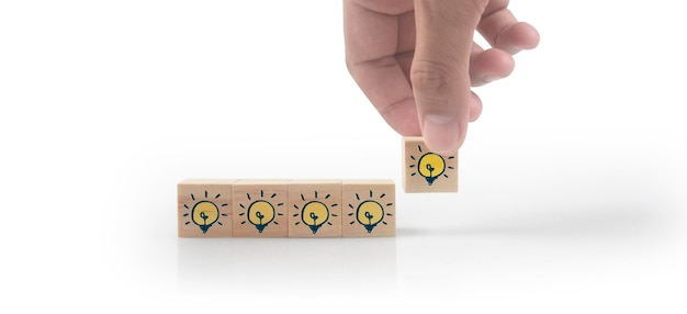 Hand putting wooden cube blocks