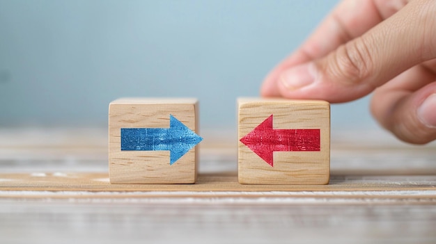 Hand putting a wooden cube with red arrow showing the opposite to blue arrows direction