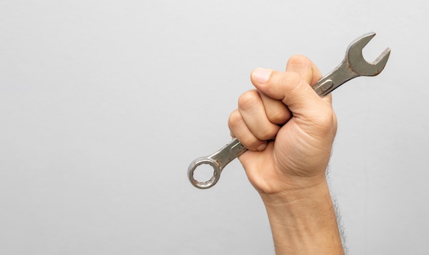 Hand's workers holding a wrench