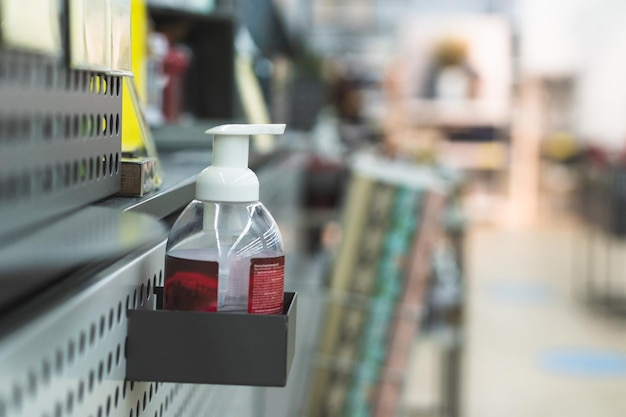 Hand sanitizer in the store at the checkout washing hands using sanitizer dispenser concept