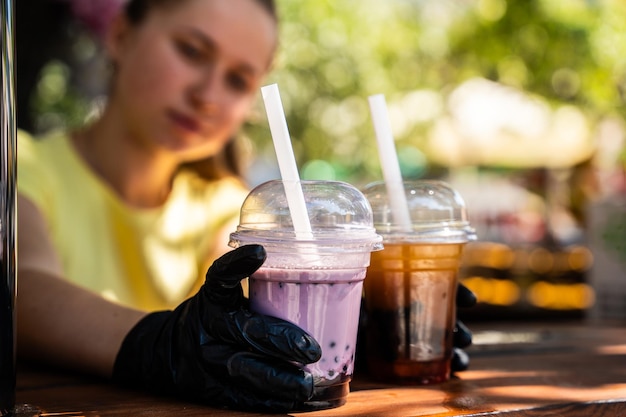 Hand Serving Bubble Tea at Outdoor Stand