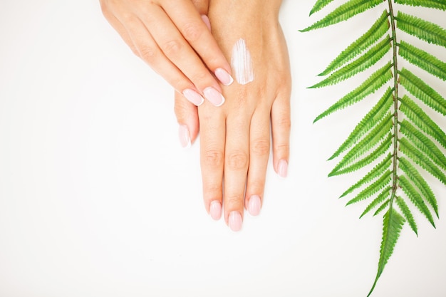 Hand skin care, woman applies moisturizer on soft silky skin