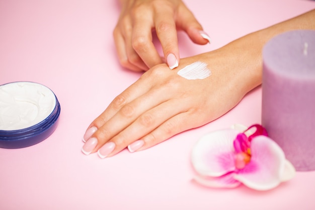 Hand skin care, woman applies moisturizer on soft silky skin