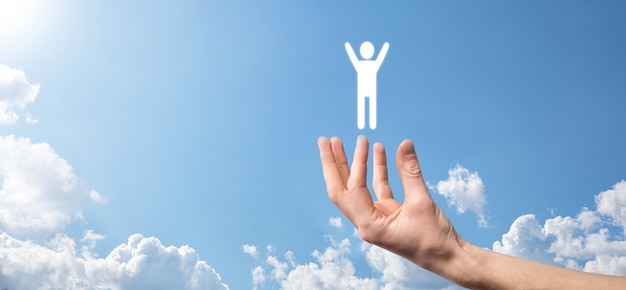 Hand on sky background holds human icon