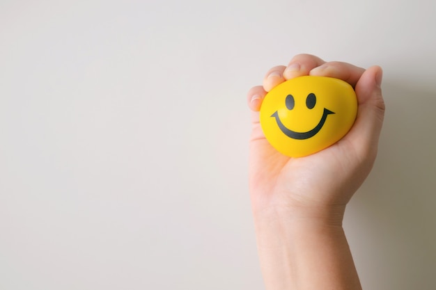 Hand squeeze yellow stress ball.