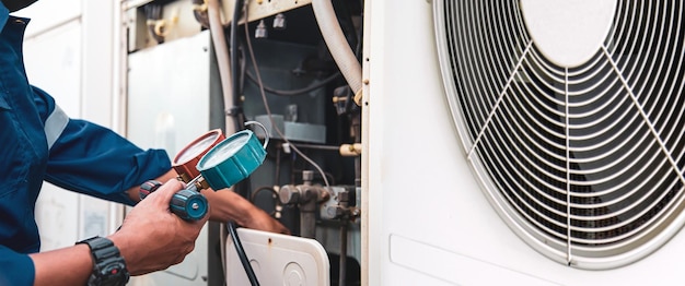 Hand technician using manifold gauge checking refrigerant air conditioner