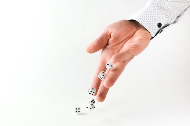 hand throws dice on white background