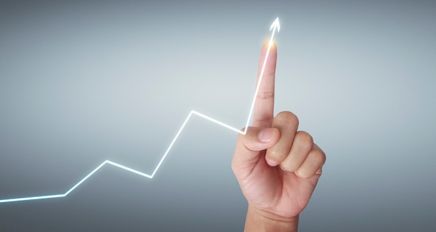 Hand touching  graphs of financial indicator and accounting market  chart