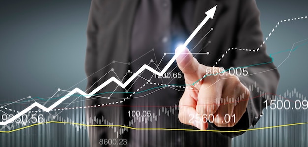 Hand touching graphs of financial indicator and accounting market economy analysis chart