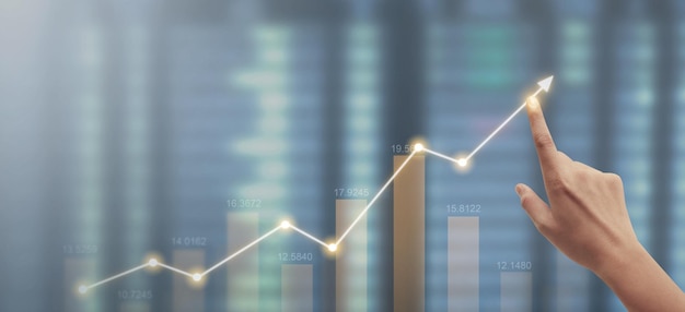 Hand touching graphs of financial indicator market analysis chart