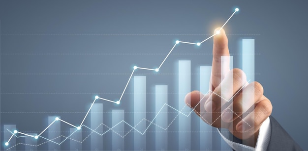 Hand touching graphs of financial indicator market analysis chart