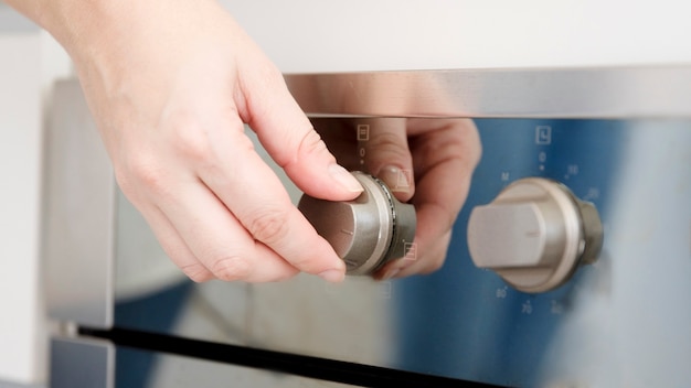 Hand turning on oven