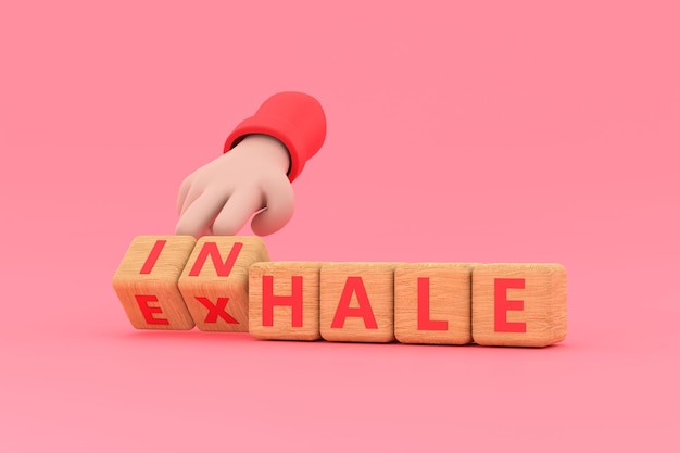 Hand turns dice and changes the word INHALE to EXHALE InhaleExhale concept