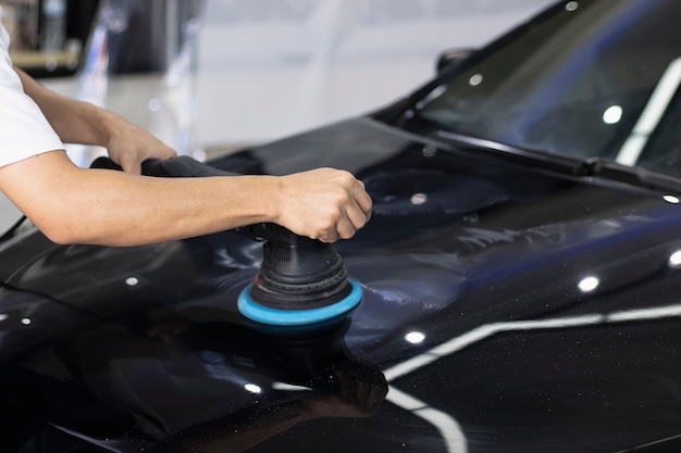 hand Using car polishing machine with car wash.