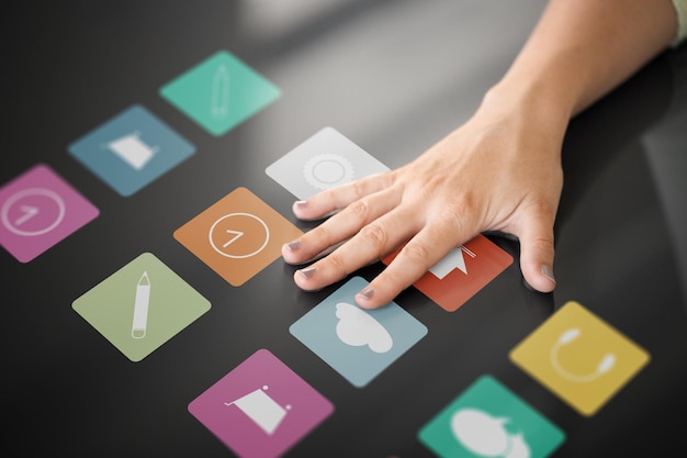 hand using interactive panel with app icons on it