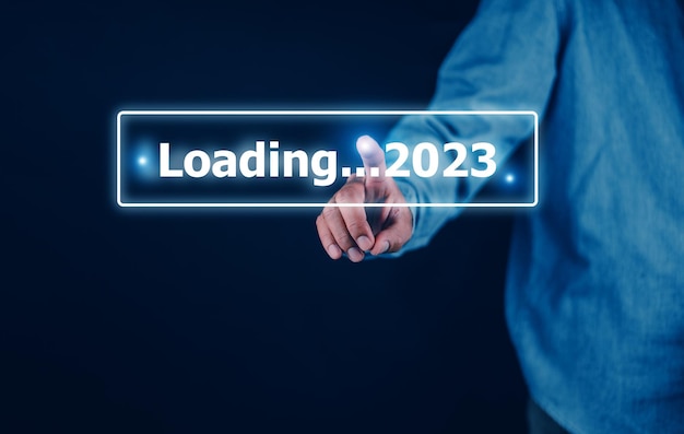 Hand using smartphone search on bar for loading 2023 start new year 2023 concept