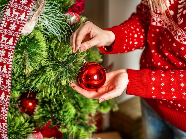 Hand with Christmas tree toy Christmas tree decoration closeup