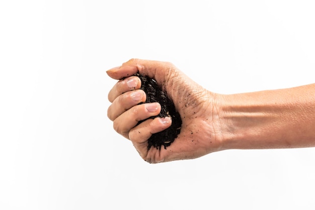 Hand with clenched fist holding soil gardening concept earth day white background