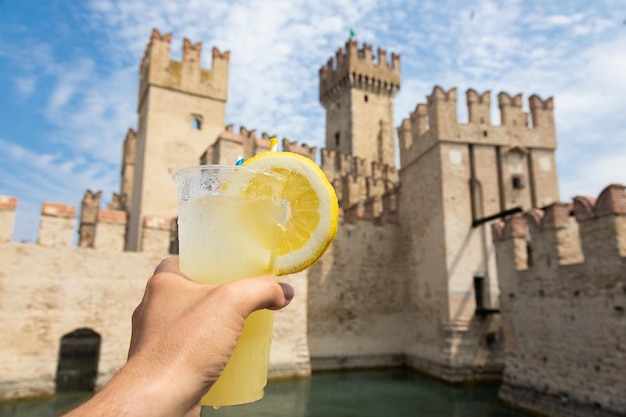 Hand with fresh cold lemonade Concept for enjoy relaxation travel summer