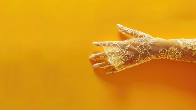 Hand with lace sleeve extended against yellow background