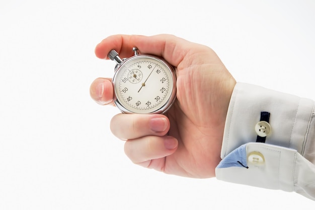 Hand with a mechanical stopwatch on a white background Time part precision Measurement of the speed interval