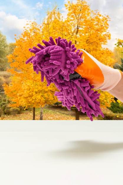 Hand with a rag on natural background