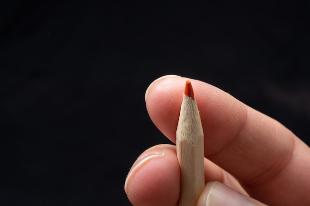 Hand with red colored pencil in hand