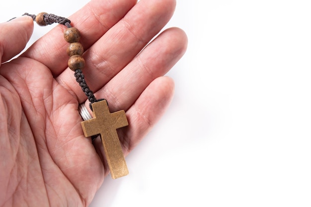 Hand with rosary catholic cross isolated on white background