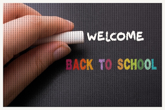 Hand with white chalk and black board