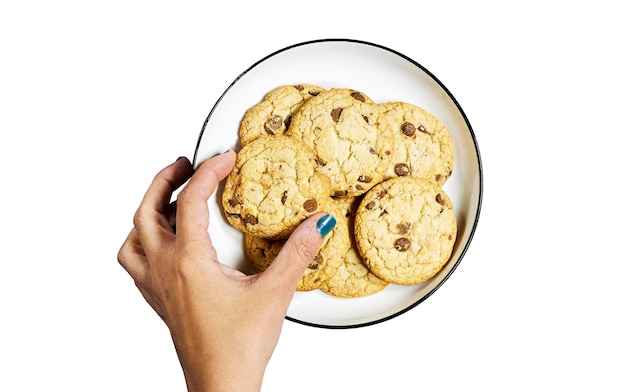 hand woman holding a homemade chocolate chip cookies a plate isolated on white