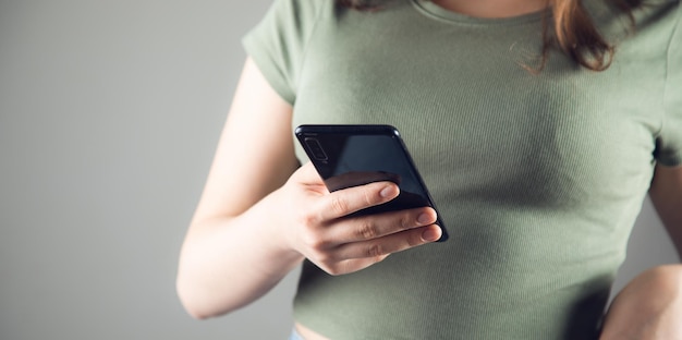 Hand of woman using smartphone