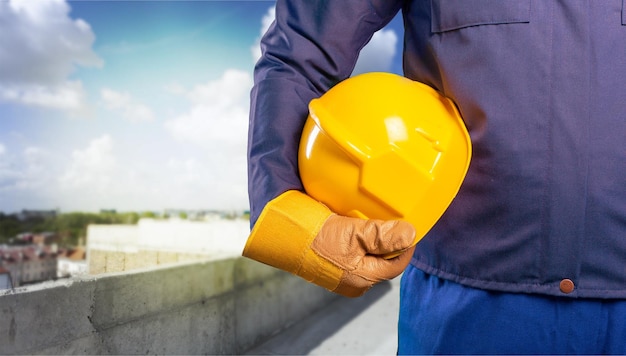 hand of worker with yellow hard-hat,natural light