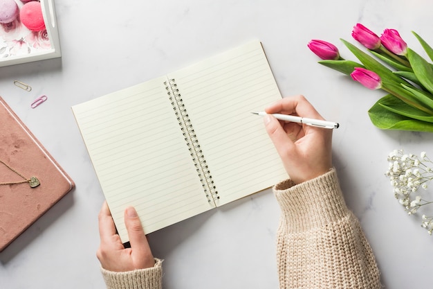 Hand writing in blank notebook