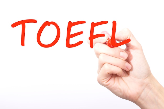 Hand writing inscription TOEFL with red color marker concept stock image