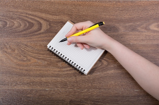 Hand writing in a Notebook on brown background