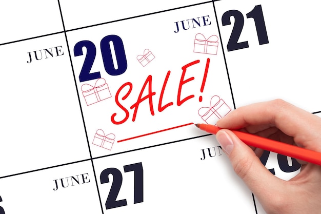 Hand writing text SALE and drawing gift boxes on calendar date June 20 Shopping Reminder