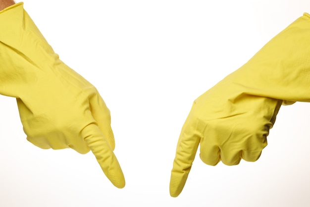 A hand in a yellow cleaner glove points to something place for text cope space