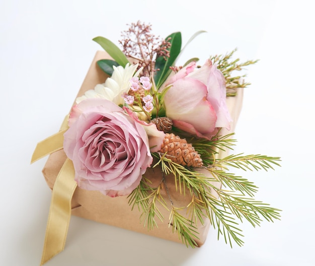 Handcrafted gift box with flowers on white background