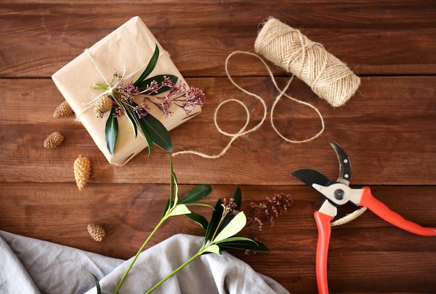 Handcrafted gift box with flowers on wooden table