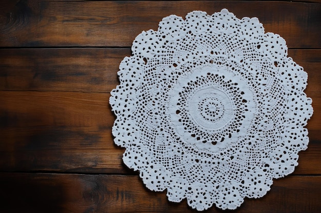 Photo handcrafted lace doily on aged wooden table