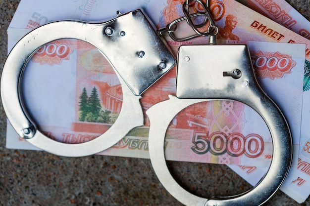 Handcuffs are on five-thousand-dollar Russian banknotes. High quality photo