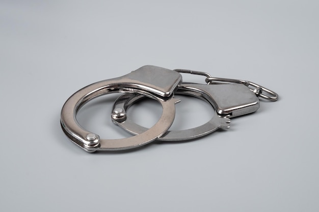 Handcuffs on a black background closeup arrest detention