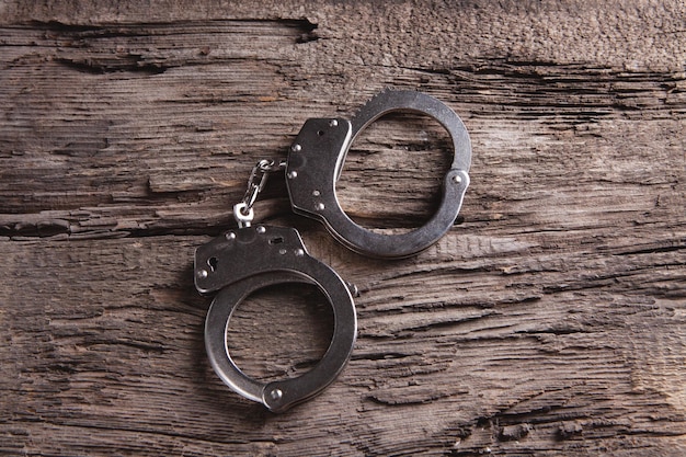 Handcuffs on a wooden table