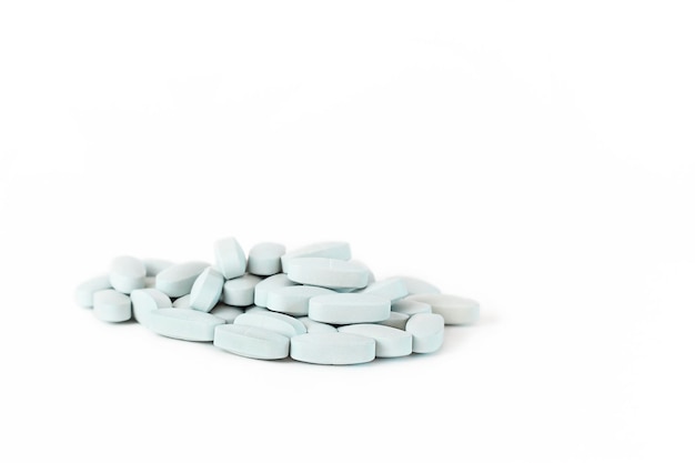 a handful of blue pills on a white background